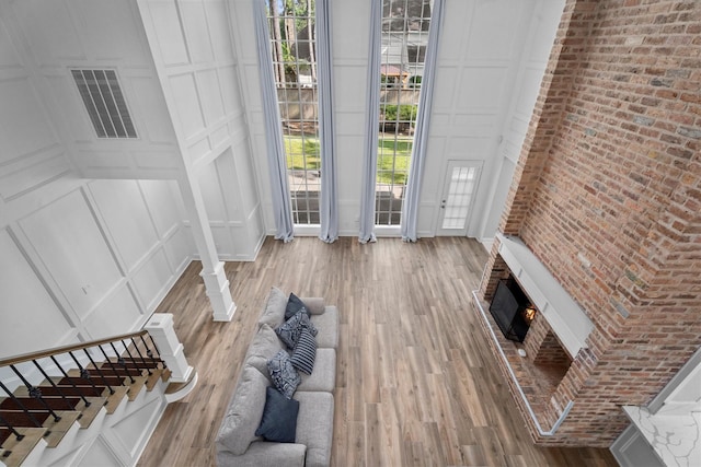 5523 Theall Rd, Houston, TX 77066 - foyer featuring a decorative wall, wood finished floors, a brick fireplace, and stairs