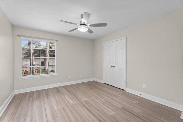 5523 Theall Rd, Houston, TX 77066 - unfurnished bedroom featuring light wood-style flooring, baseboards, a closet, and a ceiling fan