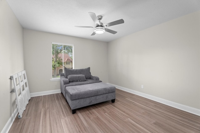 5523 Theall Rd, Houston, TX 77066 - living area with light wood-style flooring, baseboards, and ceiling fan