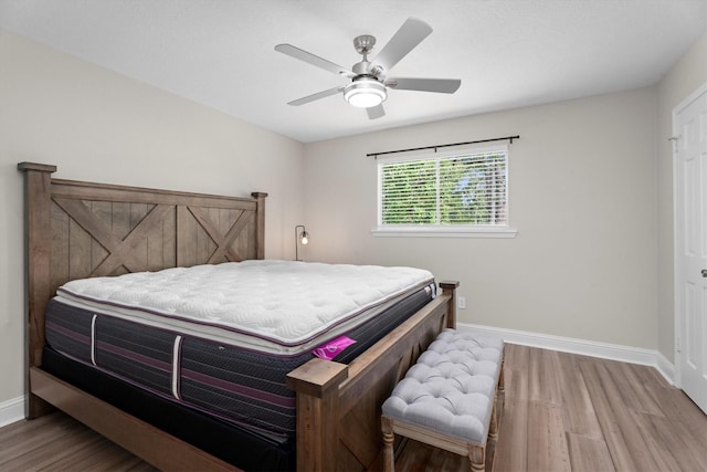 5523 Theall Rd, Houston, TX 77066 - bedroom featuring wood finished floors, baseboards, and ceiling fan