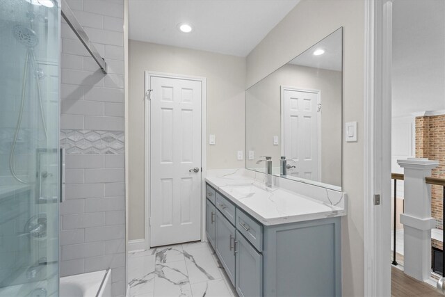 5523 Theall Rd, Houston, TX 77066 - full bath with vanity, marble look tiles, recessed lighting, bath / shower combo with glass door, and baseboards