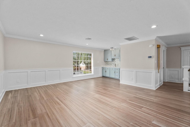 5523 Theall Rd, Houston, TX 77066 - unfurnished living room with light wood finished floors, wainscoting, recessed lighting, and crown molding