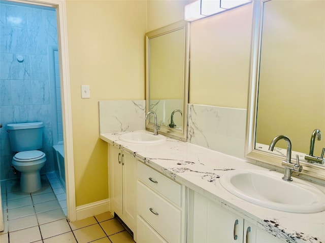 8814 Beau Monde Dr, Houston, TX 77099 - bathroom with tile patterned floors, double vanity, toilet, and baseboards