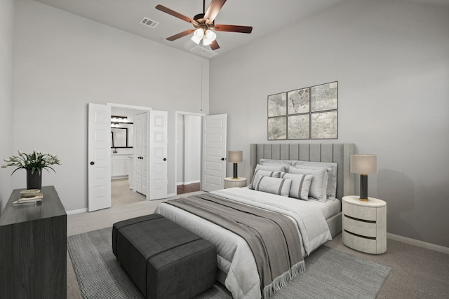 32415 Tallow Creek Dr, Waller, TX 77484 - carpeted bedroom featuring baseboards, a high ceiling, connected bathroom, and a ceiling fan