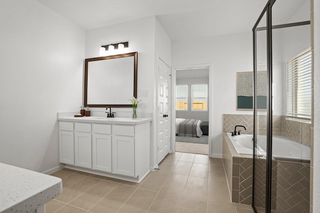 32415 Tallow Creek Dr, Waller, TX 77484 - ensuite bathroom with vanity, tile patterned floors, a bath, a shower stall, and baseboards