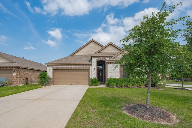 15602 Clearwater Bend Dr, Houston, TX 77044 - french country inspired facade with an attached garage, a front yard, brick siding, driveway, and stone siding