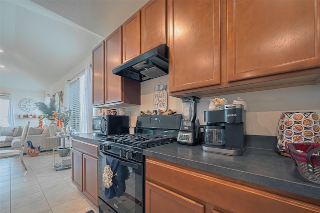 15602 Clearwater Bend Dr, Houston, TX 77044 - kitchen featuring black gas range oven, under cabinet range hood, stainless steel microwave, dark countertops, and brown cabinets