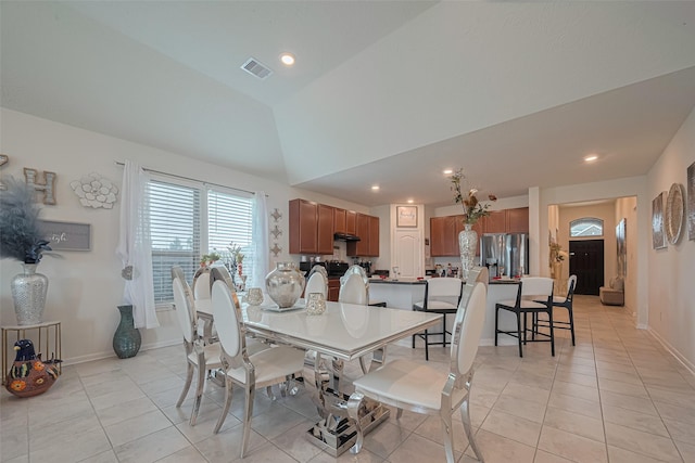 15602 Clearwater Bend Dr, Houston, TX 77044 - dining room featuring light tile patterned floors, recessed lighting, baseboards, and vaulted ceiling