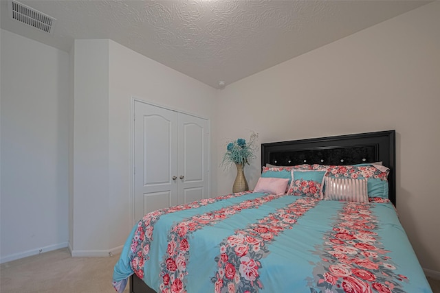 15602 Clearwater Bend Dr, Houston, TX 77044 - carpeted bedroom featuring baseboards, a closet, and a textured ceiling