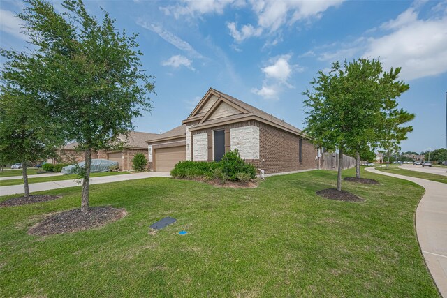15602 Clearwater Bend Dr, Houston, TX 77044 - ranch-style home with an attached garage, brick siding, concrete driveway, and stone siding