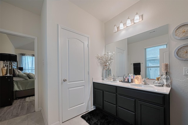 15602 Clearwater Bend Dr, Houston, TX 77044 - bathroom with double vanity, connected bathroom, tile patterned floors, and healthy amount of natural light
