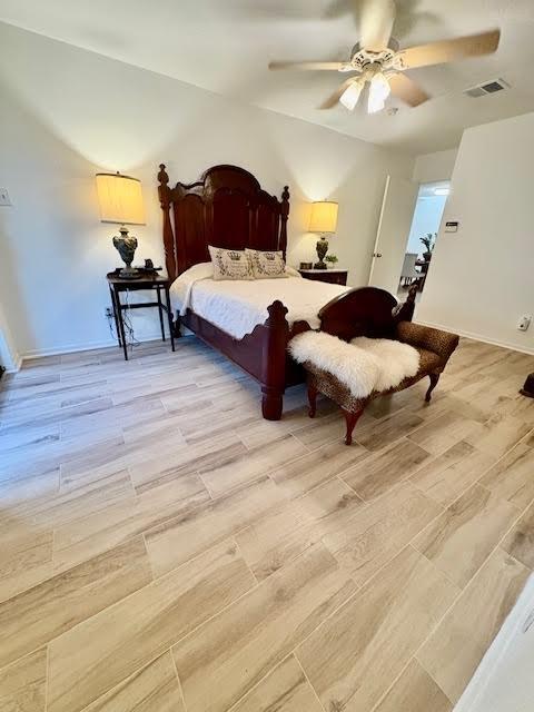 18526 Denise Dale Ln, Houston, TX 77084 - bedroom featuring light wood-type flooring, a ceiling fan, and baseboards