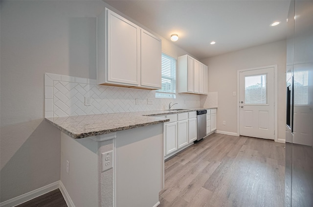 24710 Landolfi Dr, Katy, TX 77493 - kitchen featuring dishwasher, light wood finished floors, healthy amount of natural light, tasteful backsplash, and recessed lighting