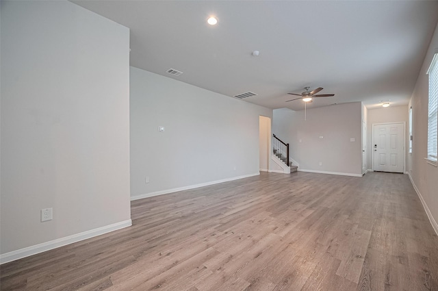 24710 Landolfi Dr, Katy, TX 77493 - unfurnished living room featuring stairway, ceiling fan, light wood-style floors, and baseboards