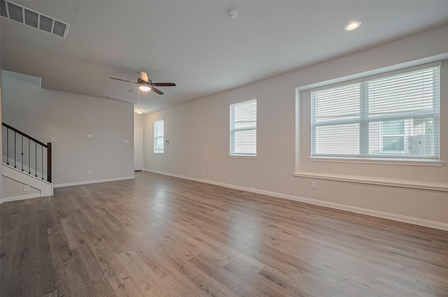 24710 Landolfi Dr, Katy, TX 77493 - unfurnished living room featuring a ceiling fan, wood finished floors, stairs, baseboards, and recessed lighting