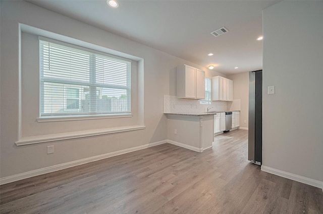 24710 Landolfi Dr, Katy, TX 77493 - kitchen with dishwasher, healthy amount of natural light, white cabinets, wood finished floors, and recessed lighting