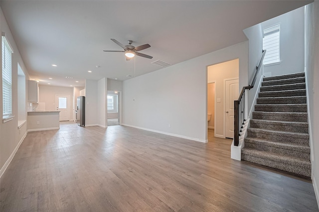 24710 Landolfi Dr, Katy, TX 77493 - unfurnished living room with ceiling fan, stairway, light wood finished floors, baseboards, and recessed lighting