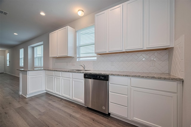 24710 Landolfi Dr, Katy, TX 77493 - kitchen featuring dishwasher, dark wood-style flooring, tasteful backsplash, white cabinets, and a peninsula