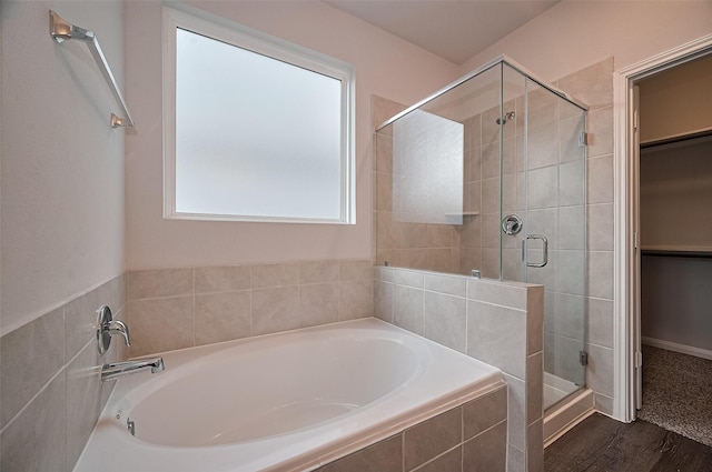 24710 Landolfi Dr, Katy, TX 77493 - bathroom with a stall shower, a spacious closet, wood finished floors, and a garden tub