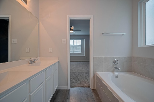 24710 Landolfi Dr, Katy, TX 77493 - full bath featuring a ceiling fan, double vanity, a garden tub, wood finished floors, and baseboards