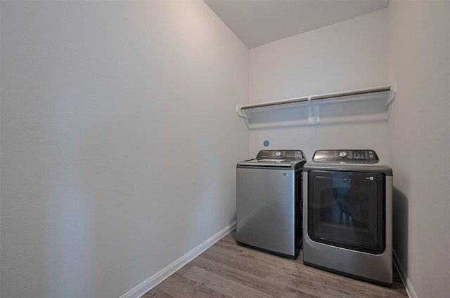 24710 Landolfi Dr, Katy, TX 77493 - laundry room featuring washing machine and dryer, wood finished floors, and baseboards
