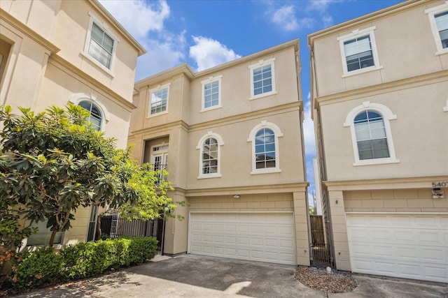 5405 Blossom St, Houston, TX 77007 - townhome / multi-family property with a garage, concrete driveway, and stucco siding