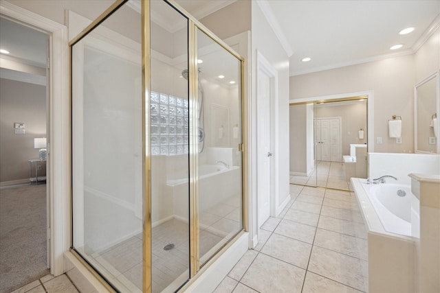 5405 Blossom St, Houston, TX 77007 - bathroom with crown molding, a shower stall, a garden tub, tile patterned flooring, and baseboards