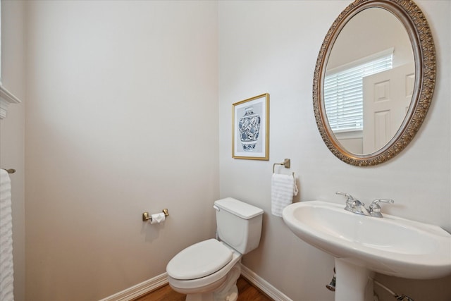 5405 Blossom St, Houston, TX 77007 - bathroom with toilet, baseboards, a sink, and wood finished floors