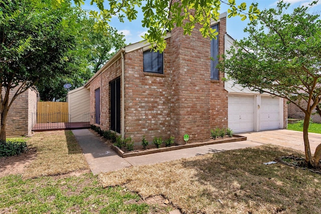 4111 Wildacres Dr, Houston, TX 77072 - view of side of home with brick siding, a garage, and driveway