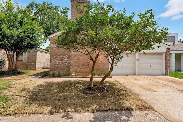 4111 Wildacres Dr, Houston, TX 77072 - view of front of house with brick siding, concrete driveway, a garage, and a chimney