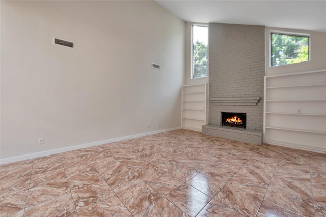 4111 Wildacres Dr, Houston, TX 77072 - unfurnished living room featuring a fireplace, baseboards, and built in shelves