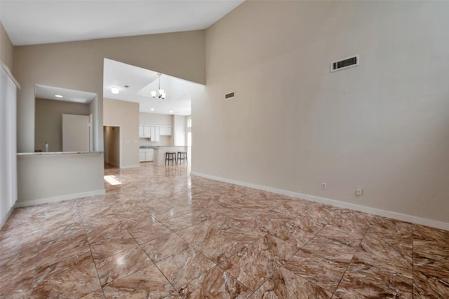 4111 Wildacres Dr, Houston, TX 77072 - unfurnished living room featuring high vaulted ceiling, marble finish flooring, a chandelier, and baseboards