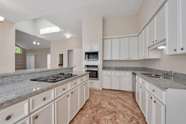 4111 Wildacres Dr, Houston, TX 77072 - kitchen featuring black appliances, a sink, a skylight, white cabinetry, and vaulted ceiling