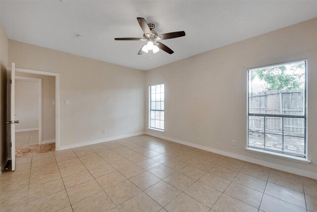 4111 Wildacres Dr, Houston, TX 77072 - spare room with light tile patterned floors, ceiling fan, and baseboards