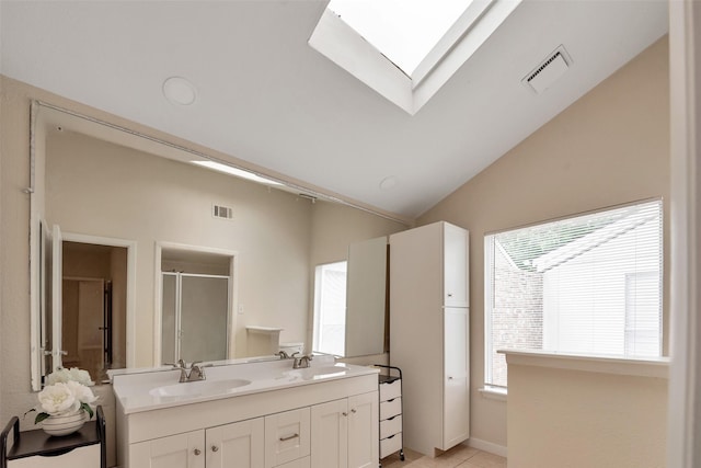 4111 Wildacres Dr, Houston, TX 77072 - bathroom featuring a skylight, a stall shower, double vanity, vaulted ceiling, and tile patterned floors
