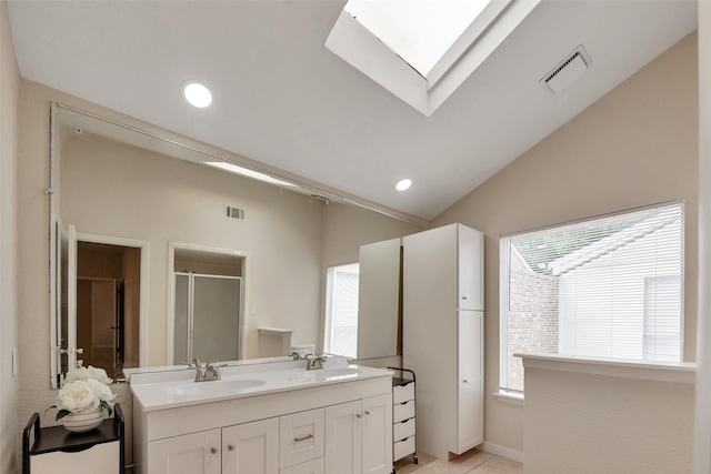 4111 Wildacres Dr, Houston, TX 77072 - bathroom featuring double vanity, a stall shower, a skylight, tile patterned flooring, and lofted ceiling