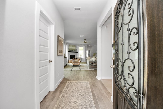 2142 Emerald Diamond Ct, Fresno, TX 77545 - entryway with ceiling fan, baseboards, a fireplace, and light wood-type flooring
