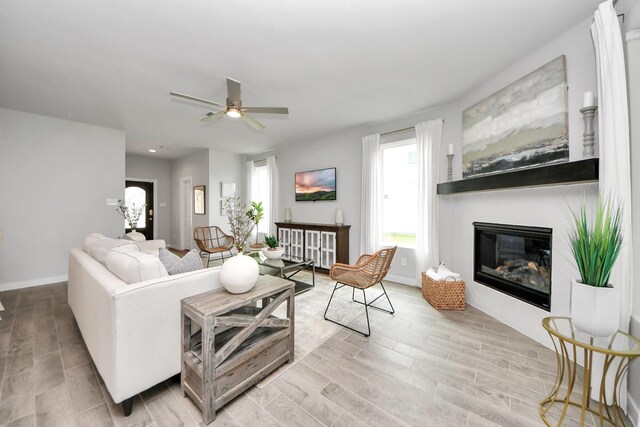 2142 Emerald Diamond Ct, Fresno, TX 77545 - living room featuring healthy amount of natural light, wood finished floors, ceiling fan, a glass covered fireplace, and recessed lighting