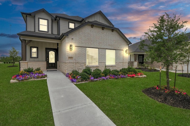 2142 Emerald Diamond Ct, Fresno, TX 77545 - view of front of property featuring board and batten siding, stone siding, and a lawn