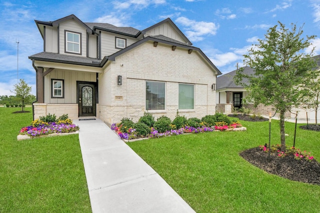 2142 Emerald Diamond Ct, Fresno, TX 77545 - craftsman house with board and batten siding, stone siding, and a front lawn
