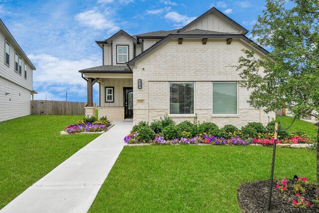 2142 Emerald Diamond Ct, Fresno, TX 77545 - view of front facade featuring board and batten siding, stone siding, and a porch