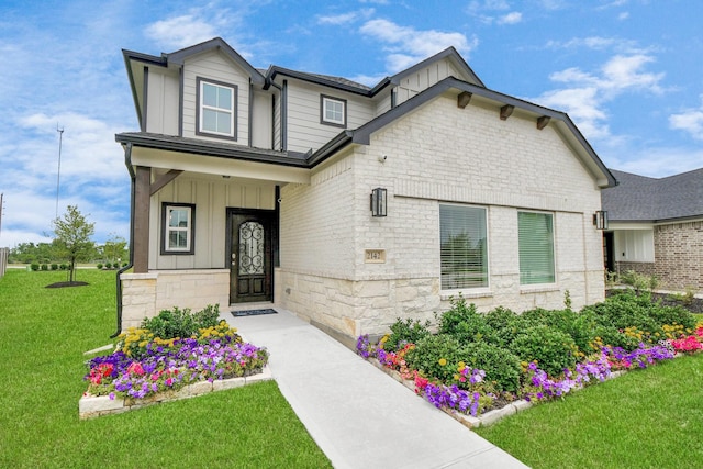 2142 Emerald Diamond Ct, Fresno, TX 77545 - view of front of home with board and batten siding, stone siding, and a front yard