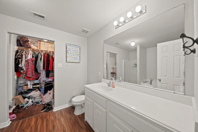 4603 Poppy Crest Ct, Richmond, TX 77469 - full bath featuring wood finished floors, vanity, toilet, baseboards, and a walk in closet