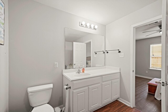 4603 Poppy Crest Ct, Richmond, TX 77469 - ensuite bathroom with wood finished floors, vanity, toilet, ceiling fan, and baseboards