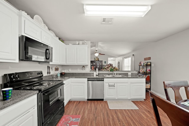 4603 Poppy Crest Ct, Richmond, TX 77469 - kitchen with black appliances, a sink, light wood finished floors, white cabinetry, and lofted ceiling