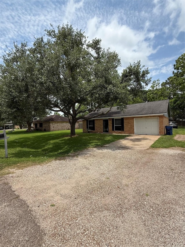 624 Houston St, West Columbia, TX 77486 - single story home with concrete driveway, an attached garage, brick siding, and a front lawn