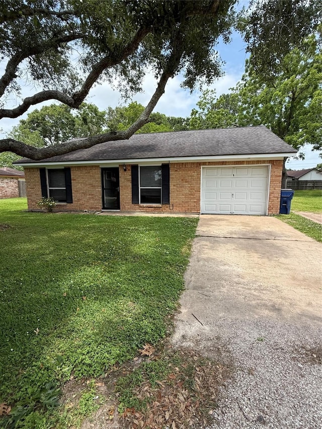 624 Houston St, West Columbia, TX 77486 - view of front facade with an attached garage, a front lawn, concrete driveway, brick siding, and a shingled roof