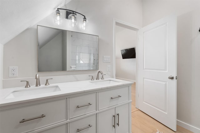175 Autumn Wood Trl, Gun Barrel City, TX 75156 - bathroom featuring wood finished floors, double vanity, and lofted ceiling