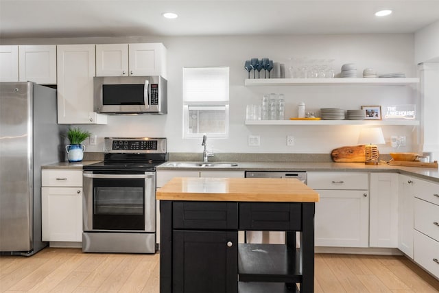 175 Autumn Wood Trl, Gun Barrel City, TX 75156 - kitchen with stainless steel appliances, a sink, wood counters, open shelves, and light wood-style floors