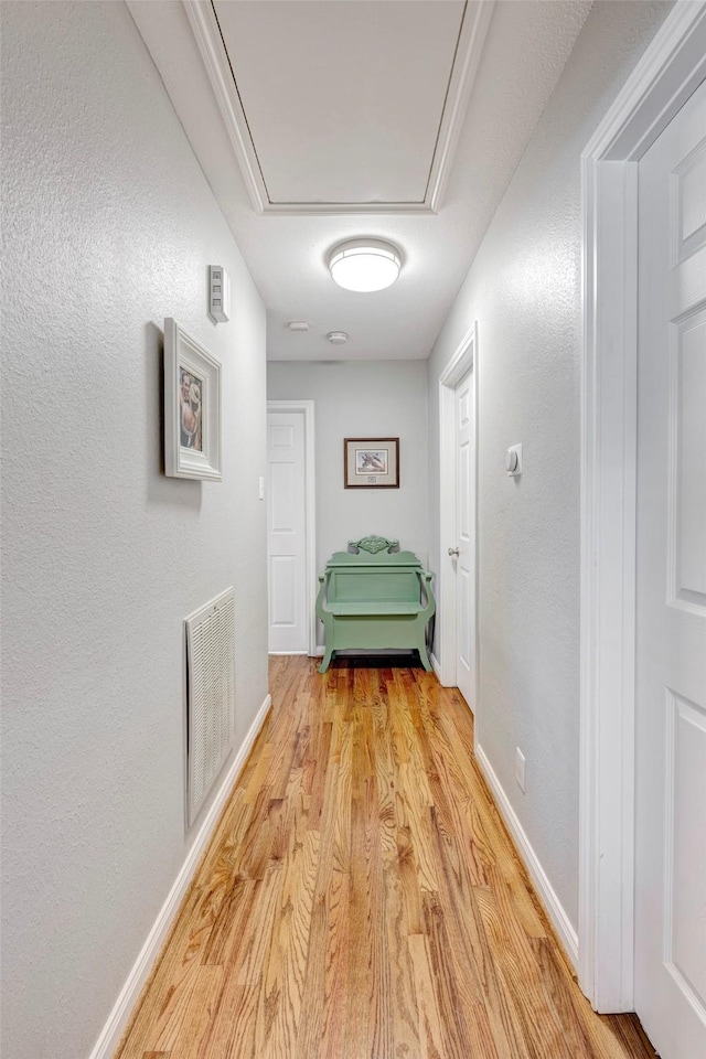 1023 Waltway Dr, Houston, TX 77008 - corridor featuring light wood finished floors, attic access, and baseboards